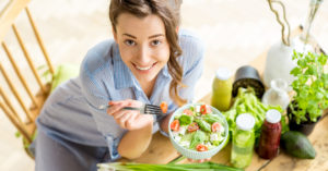 Woman Eating Salad with Apple Cider Vinegar Dressing